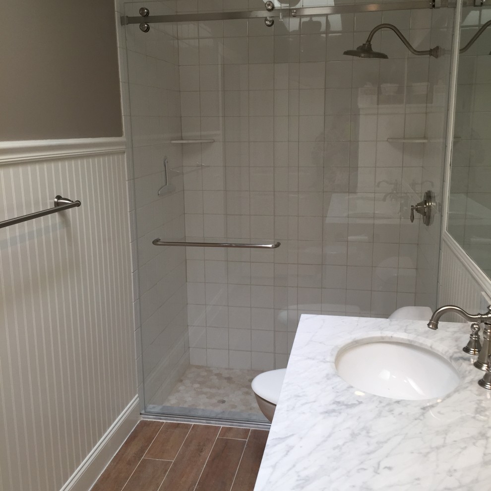 Example of a mid-sized beach style master white tile and porcelain tile ceramic tile double shower design in Miami with an undermount sink, beaded inset cabinets, white cabinets, marble countertops, a one-piece toilet and beige walls