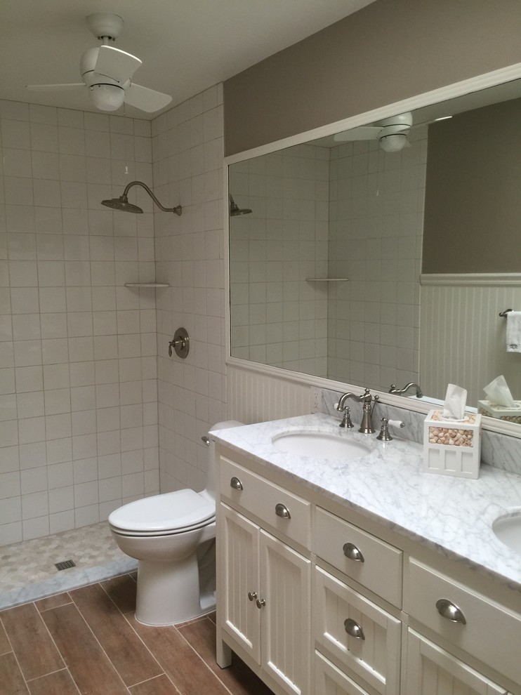 Mid-sized beach style master white tile and porcelain tile ceramic tile double shower photo in Miami with an undermount sink, beaded inset cabinets, white cabinets, marble countertops, a one-piece toilet and beige walls