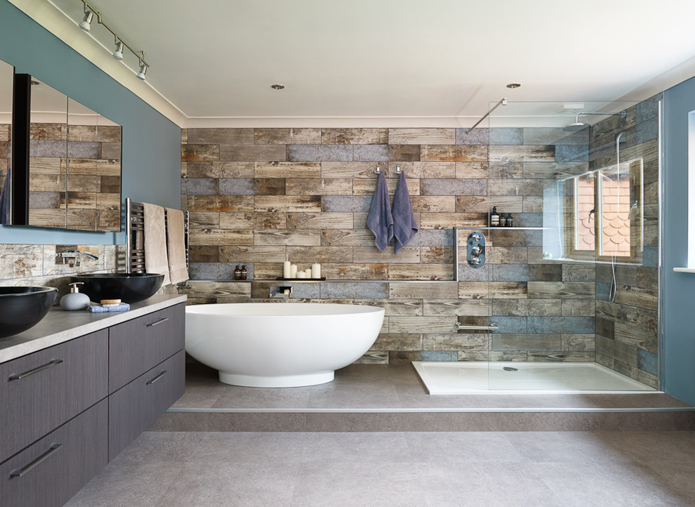 Bathroom - large contemporary master blue tile and porcelain tile vinyl floor and gray floor bathroom idea in Sussex with dark wood cabinets, a wall-mount toilet, blue walls, a vessel sink, laminate countertops and gray countertops