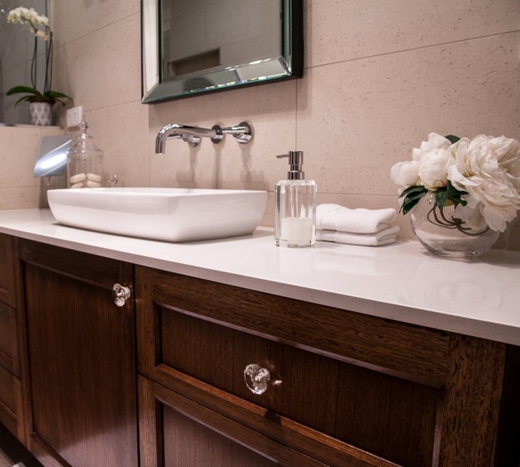 Contemporary ensuite bathroom in Melbourne with a vessel sink, shaker cabinets, dark wood cabinets, engineered stone worktops, a walk-in shower, beige tiles, porcelain tiles, beige walls and porcelain flooring.