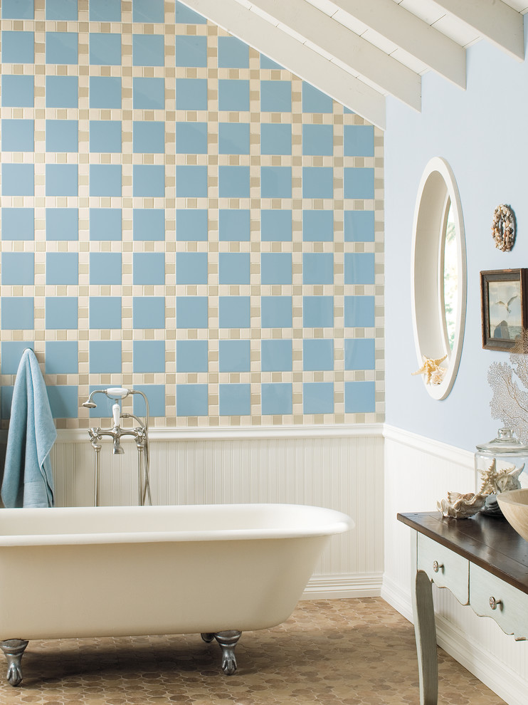 Foto på ett maritimt badrum, med mosaik, mosaikgolv, ett badkar med tassar, blå kakel och blå väggar