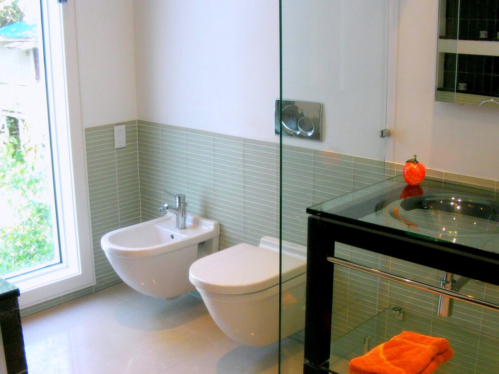 Cette photo montre une salle de bain principale moderne de taille moyenne avec un bain bouillonnant, une douche double, WC à poser, un carrelage vert, un carrelage en pâte de verre, un mur blanc, un sol en carrelage de porcelaine, un lavabo intégré, un plan de toilette en verre, un sol beige et aucune cabine.