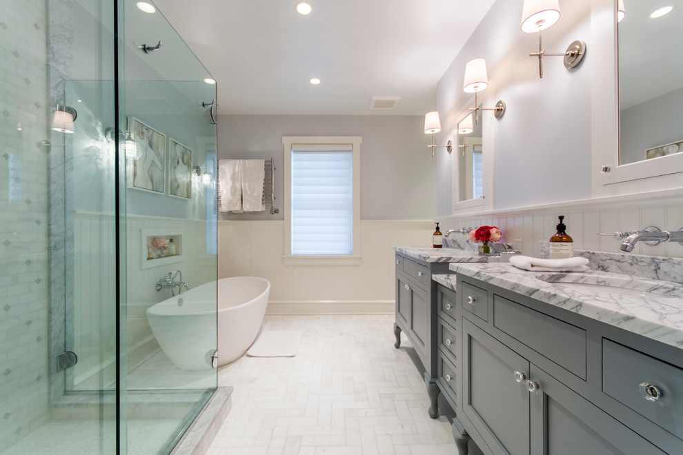 Inspiration for a classic bathroom in Philadelphia with a submerged sink, grey cabinets, a freestanding bath, a corner shower, grey walls, recessed-panel cabinets and white floors.
