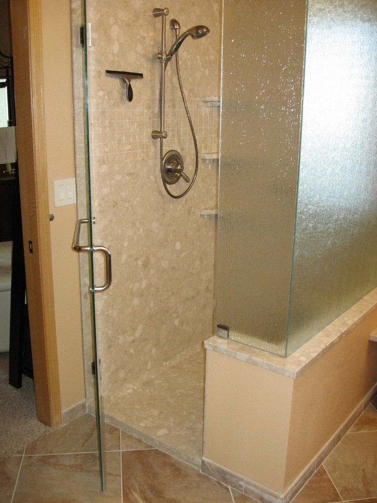 Inspiration for a large classic ensuite bathroom in Denver with shaker cabinets, dark wood cabinets, an alcove shower, beige tiles, mosaic tiles, beige walls, ceramic flooring, a submerged sink and solid surface worktops.