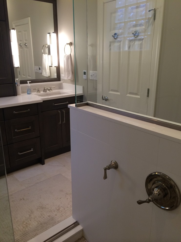 Photo of a medium sized classic ensuite bathroom in Chicago with recessed-panel cabinets, dark wood cabinets, a corner shower, a two-piece toilet, yellow tiles, porcelain tiles, porcelain flooring, a submerged sink, quartz worktops and beige walls.
