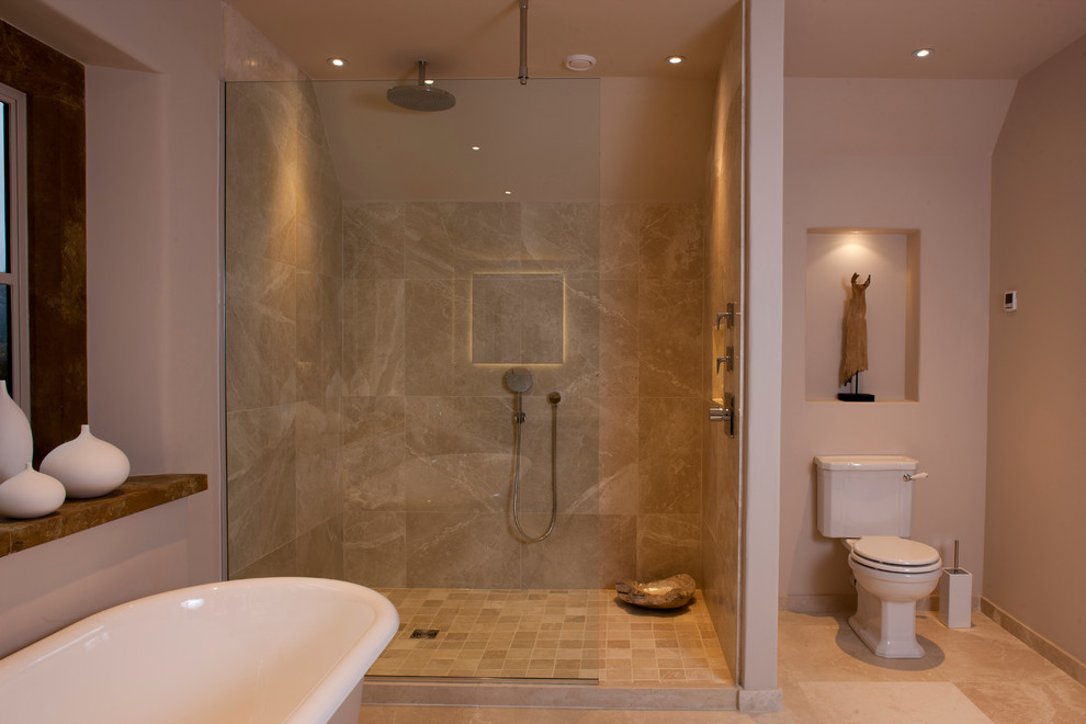 Inspiration for a large contemporary kids' beige tile and mosaic tile limestone floor bathroom remodel in West Midlands with a one-piece toilet and beige walls