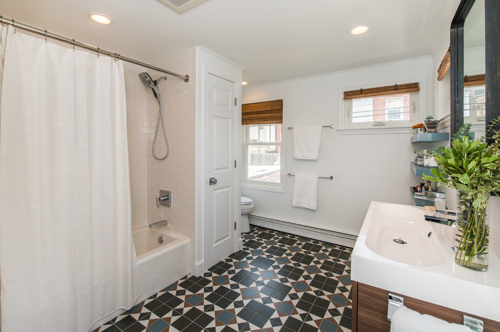 Bathroom - mid-sized transitional 3/4 ceramic tile and multicolored floor bathroom idea in Baltimore with flat-panel cabinets, medium tone wood cabinets, white walls, an integrated sink, quartz countertops and white countertops