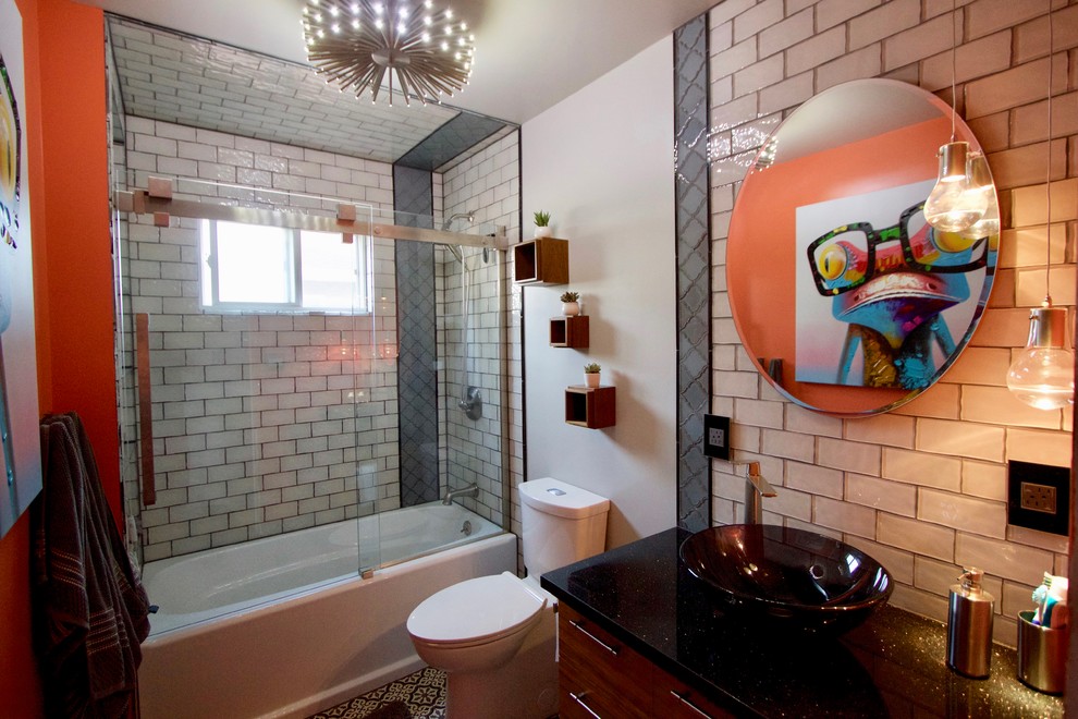Minimalist kids' beige tile and glass tile cement tile floor and black floor bathroom photo in San Francisco with flat-panel cabinets, dark wood cabinets, a one-piece toilet, orange walls, a vessel sink, granite countertops and black countertops