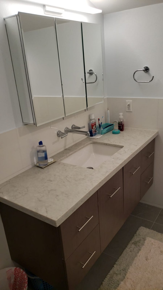 Medium sized bathroom in Los Angeles with flat-panel cabinets, brown cabinets, granite worktops, beige floors, beige worktops and an enclosed toilet.