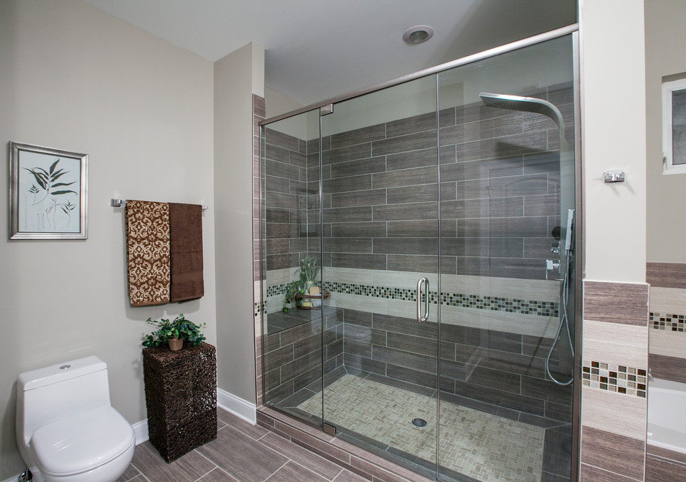 Mid-sized trendy 3/4 beige tile bathroom photo in Chicago with glass-front cabinets and tile countertops