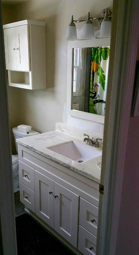This is an example of a medium sized classic family bathroom in DC Metro with shaker cabinets, white cabinets, an alcove bath, a shower/bath combination, a two-piece toilet, beige walls, a submerged sink, engineered stone worktops and a shower curtain.