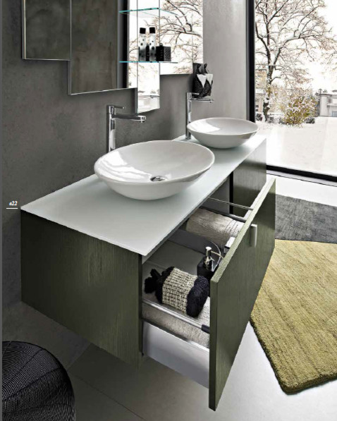 Bild på ett litet funkis badrum med dusch, med luckor med upphöjd panel, bruna skåp, marmorbänkskiva, vit kakel, grå väggar och betonggolv