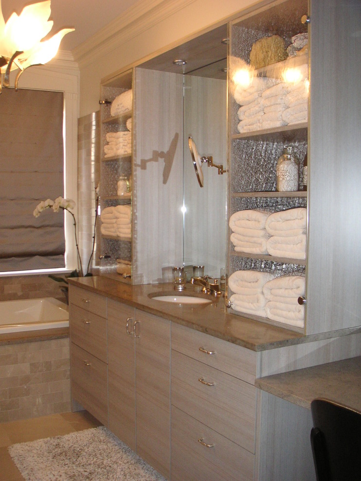 Medium sized contemporary bathroom in DC Metro with flat-panel cabinets, grey cabinets, a built-in bath, grey tiles, stone tiles, white walls, limestone flooring, a submerged sink and limestone worktops.