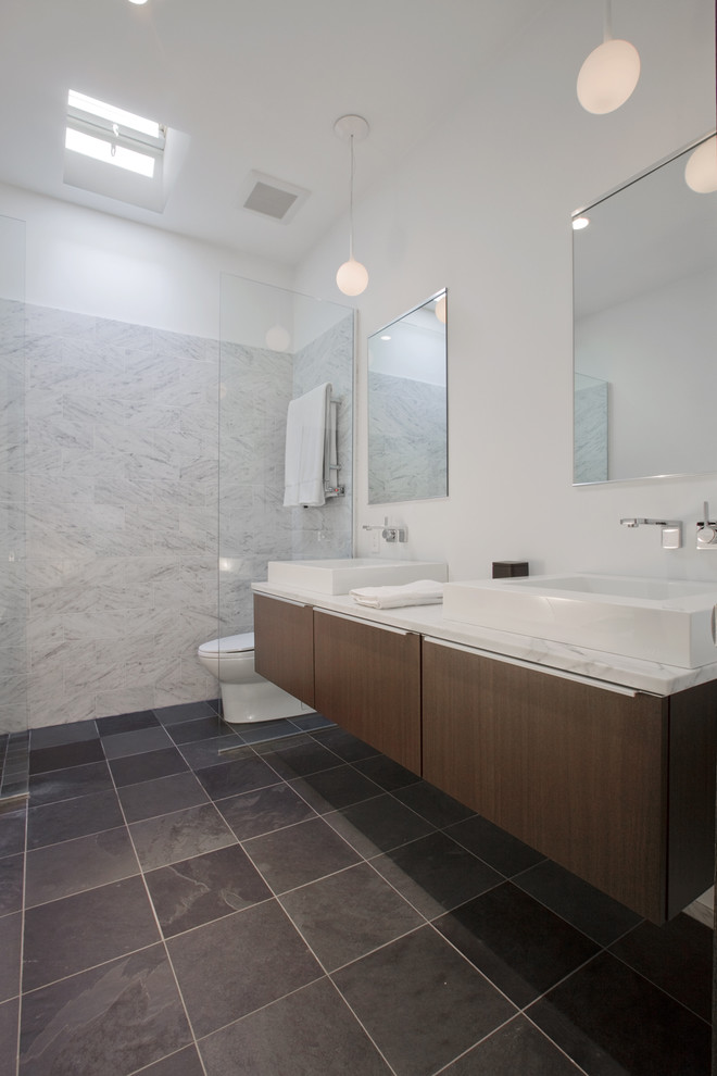 Photo of a medium sized contemporary ensuite bathroom in Minneapolis with a vessel sink, flat-panel cabinets, a built-in shower, grey tiles, slate flooring, marble worktops, stone tiles and dark wood cabinets.