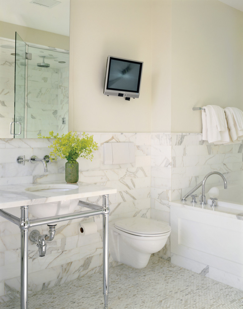 Example of a trendy marble tile bathroom design in New York with a wall-mount toilet and a console sink
