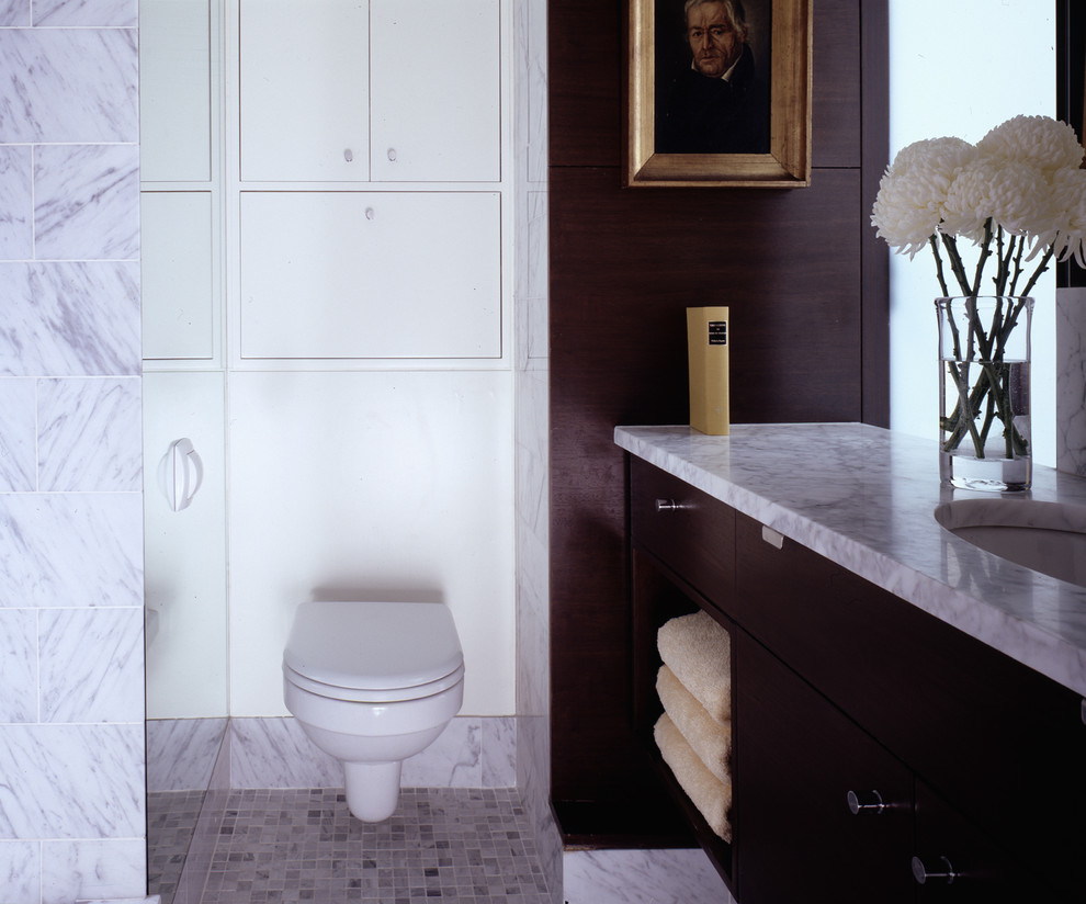 This is an example of a contemporary bathroom in New York with a wall mounted toilet.