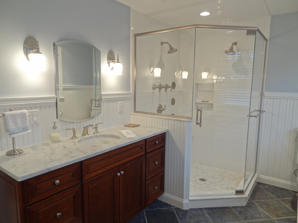 Large trendy master porcelain tile corner shower photo in Boston with an undermount sink, beaded inset cabinets, medium tone wood cabinets, marble countertops, a two-piece toilet and blue walls