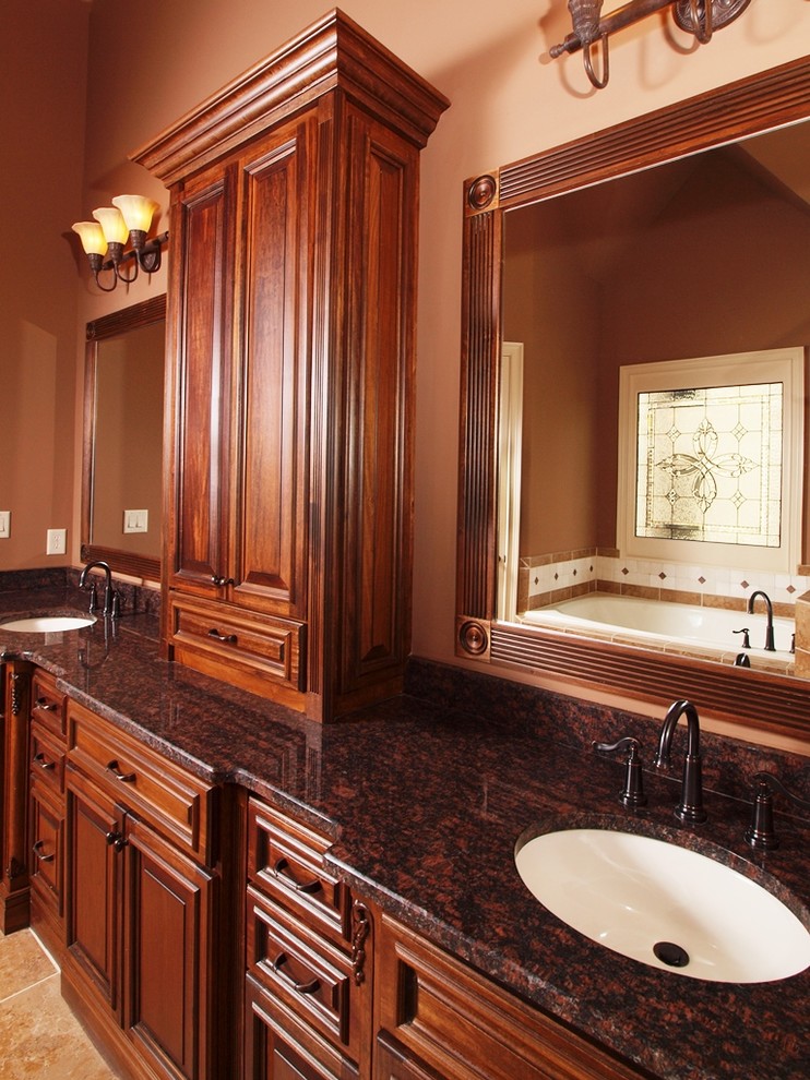 На фото: главная ванная комната в классическом стиле с накладной раковиной, фасадами с выступающей филенкой, накладной ванной, оранжевыми стенами и темными деревянными фасадами
