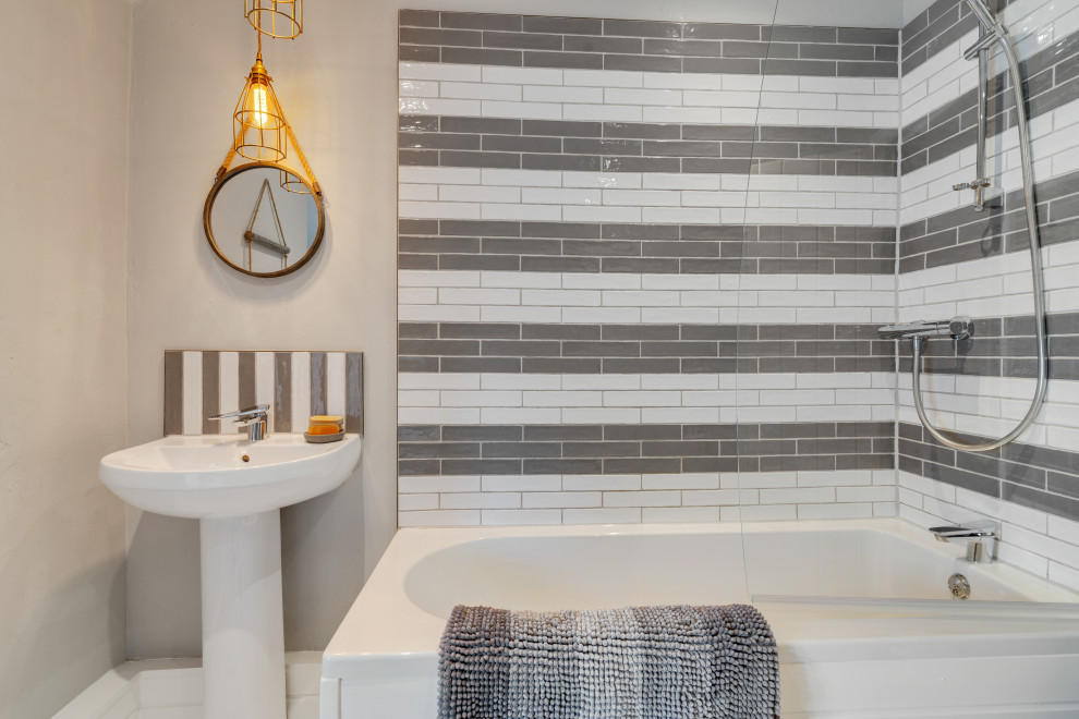 Inspiration for a mid-sized coastal master gray tile and terra-cotta tile painted wood floor, white floor, single-sink and shiplap wall bathroom remodel in Cheshire with a wall-mount toilet, gray walls, a pedestal sink, a hinged shower door and a freestanding vanity