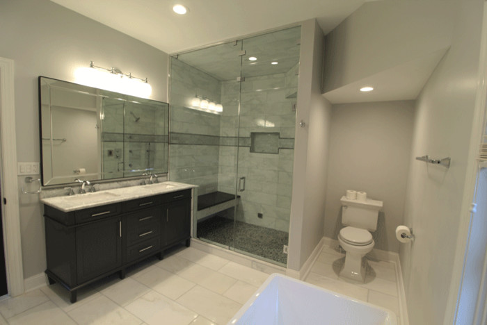 This is an example of a large classic shower room bathroom in Philadelphia with shaker cabinets, dark wood cabinets, an alcove shower, a two-piece toilet, grey tiles, marble tiles, grey walls, marble flooring, a submerged sink, marble worktops, grey floors and a hinged door.