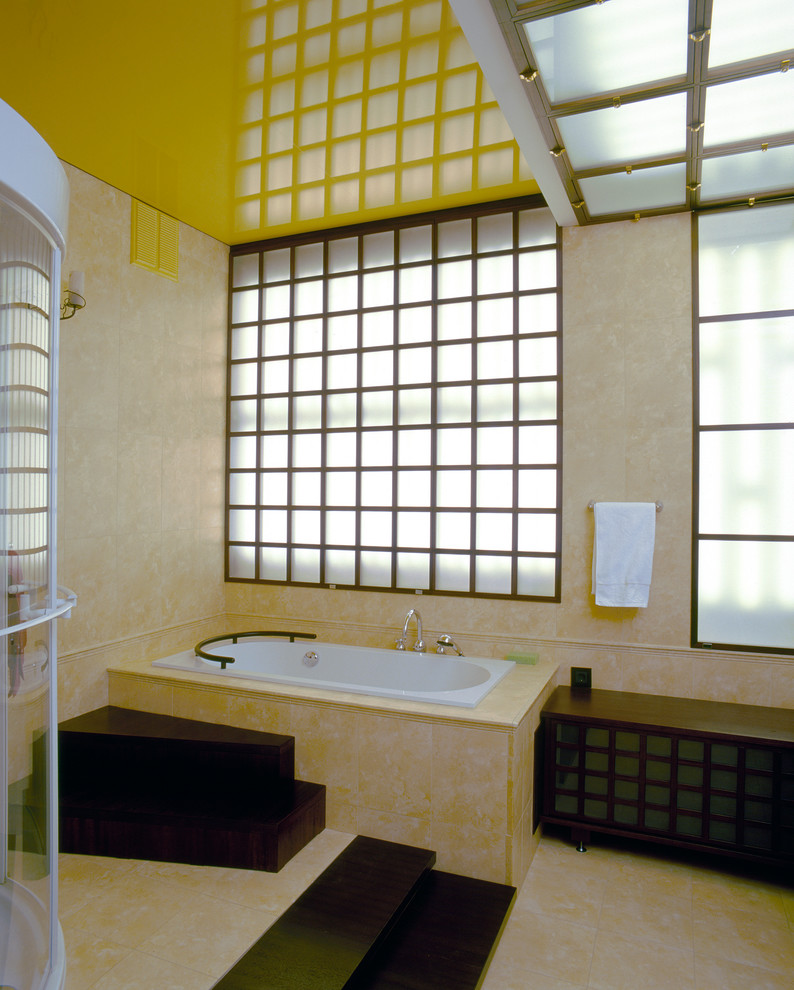 Idées déco pour une salle de bain principale contemporaine en bois foncé de taille moyenne avec un placard en trompe-l'oeil, une baignoire posée, une douche d'angle, WC suspendus, un carrelage beige, des dalles de pierre, un mur beige, un sol en marbre, un lavabo posé et un plan de toilette en carrelage.