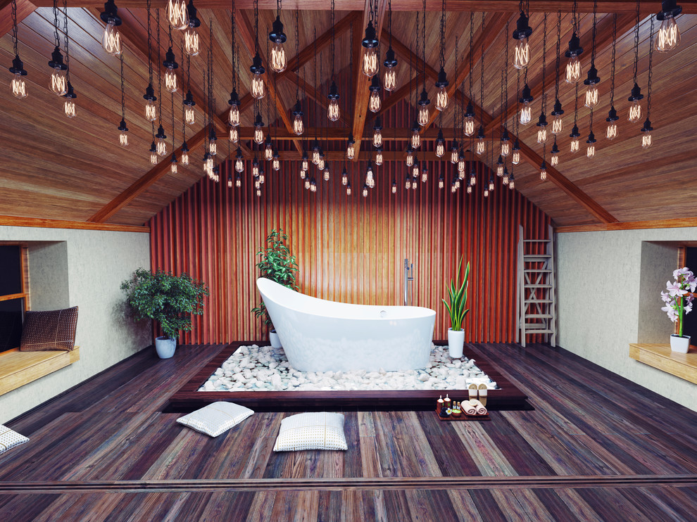 Dark wood floor freestanding bathtub photo in Los Angeles