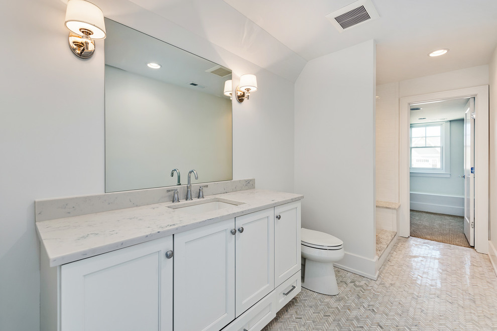 Mid-sized transitional 3/4 white tile and subway tile white floor and mosaic tile floor bathroom photo in Chicago with shaker cabinets, white cabinets, a two-piece toilet, an undermount sink, granite countertops, black countertops and gray walls