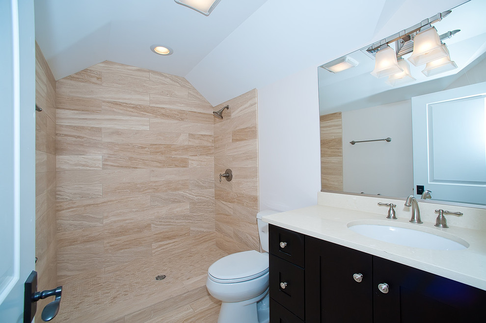 Cette photo montre une salle de bain chic de taille moyenne avec un placard à porte shaker, des portes de placard noires, WC séparés, un carrelage beige, des carreaux de porcelaine, un mur blanc, sol en stratifié, un lavabo encastré, un plan de toilette en quartz, un sol marron et un plan de toilette blanc.