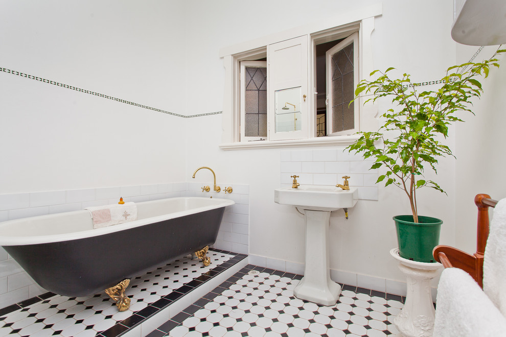 Идея дизайна: ванная комната в современном стиле с раковиной с пьедесталом, ванной на ножках, белой плиткой, плиткой кабанчик, белыми стенами, полом из керамической плитки и разноцветным полом
