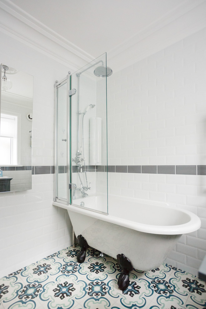 Design ideas for a small traditional family bathroom in Dorset with shaker cabinets, grey cabinets, a claw-foot bath, a shower/bath combination, a one-piece toilet, white tiles, white walls, cement flooring, an integrated sink, engineered stone worktops, multi-coloured floors and a hinged door.