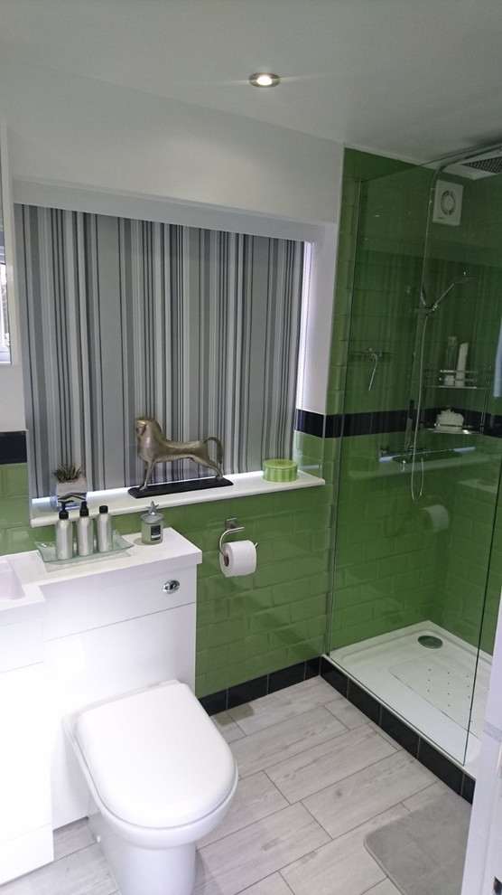 This is an example of a small modern shower room bathroom in Kent with white cabinets, a walk-in shower, green tiles, ceramic tiles, white walls, ceramic flooring and a built-in sink.