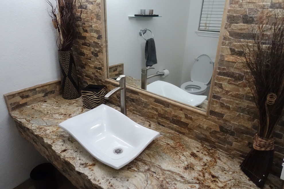 Bathroom - small rustic 3/4 beige tile and stone tile bathroom idea in Austin with a two-piece toilet, white walls, a vessel sink, granite countertops and brown countertops