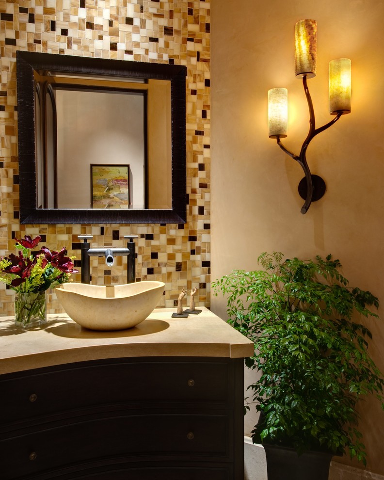 Ispirazione per una piccola stanza da bagno mediterranea con consolle stile comò, ante in legno bruno, vasca freestanding, piastrelle multicolore, piastrelle a mosaico, pareti beige, pavimento in travertino, lavabo a bacinella, top in marmo e pavimento beige