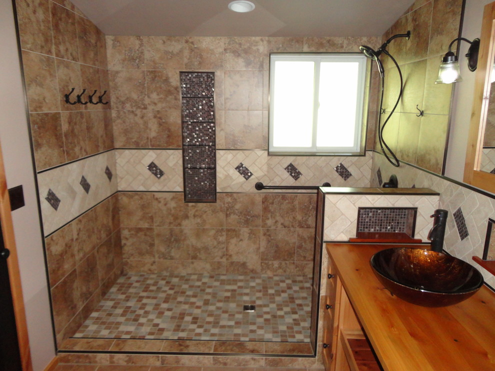 Medium sized rustic ensuite bathroom in Oklahoma City with a vessel sink, light wood cabinets, wooden worktops, a walk-in shower, a two-piece toilet, beige tiles, porcelain tiles, beige walls and porcelain flooring.
