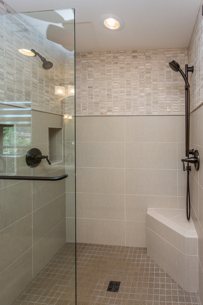 Klassisk inredning av ett stort en-suite badrum, med luckor med upphöjd panel, skåp i mörkt trä, ett fristående badkar, en dusch i en alkov, grå kakel, cementkakel, beige väggar, klinkergolv i keramik, ett undermonterad handfat, marmorbänkskiva, brunt golv och dusch med gångjärnsdörr