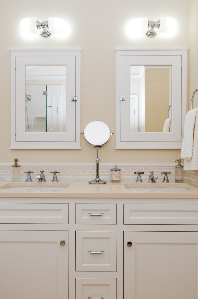 Elegant beige tile bathroom photo in DC Metro with an undermount sink, recessed-panel cabinets and white cabinets