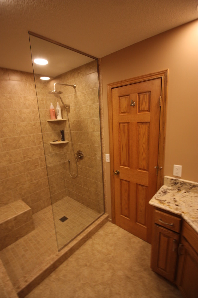 Design ideas for a medium sized classic ensuite bathroom in Minneapolis with a submerged sink, raised-panel cabinets, medium wood cabinets, granite worktops, a built-in bath, a walk-in shower, a two-piece toilet, beige tiles, ceramic tiles, beige walls and ceramic flooring.