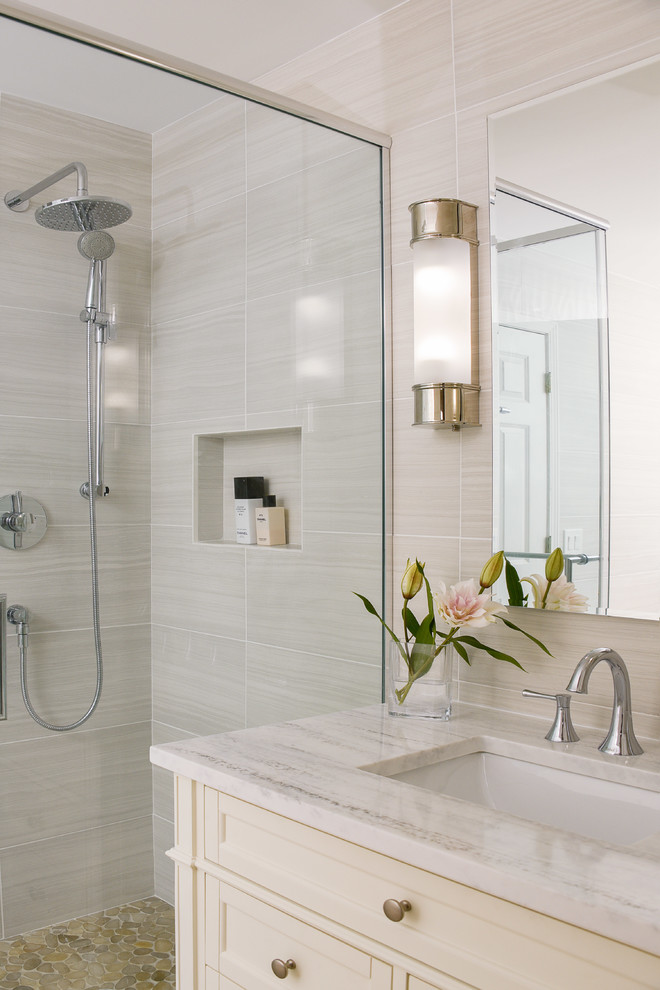 This is an example of a small contemporary bathroom in Chicago with freestanding cabinets, white cabinets, a freestanding bath, a corner shower, a two-piece toilet, grey tiles, porcelain tiles, grey walls, porcelain flooring, a submerged sink, engineered stone worktops, grey floors and a hinged door.