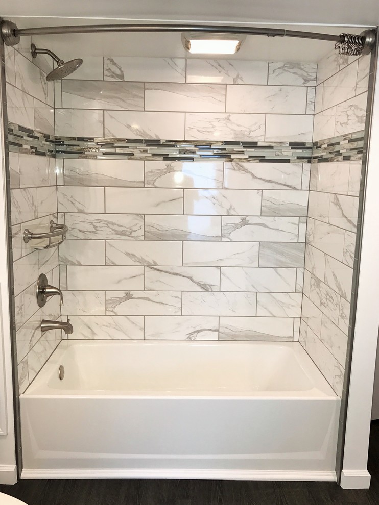 Medium sized traditional ensuite bathroom in Philadelphia with recessed-panel cabinets, grey cabinets, a built-in bath, a shower/bath combination, a one-piece toilet, black and white tiles, marble tiles, white walls, a submerged sink, marble worktops and a shower curtain.