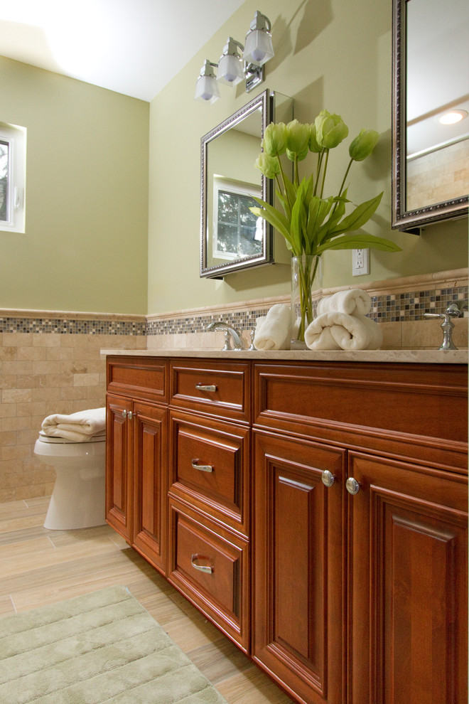 Idéer för mellanstora vintage beige en-suite badrum, med luckor med upphöjd panel, skåp i mellenmörkt trä, gröna väggar, klinkergolv i porslin, ett undermonterad handfat, en dusch i en alkov, en toalettstol med separat cisternkåpa, beige kakel, stenkakel, marmorbänkskiva, beiget golv och dusch med gångjärnsdörr