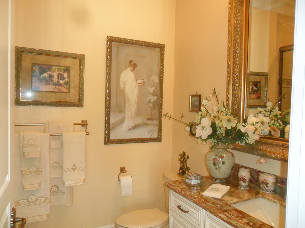 Inspiration for a medium sized victorian bathroom in Miami with raised-panel cabinets, white cabinets, a two-piece toilet, beige walls, porcelain flooring, a submerged sink, granite worktops, beige floors and brown worktops.