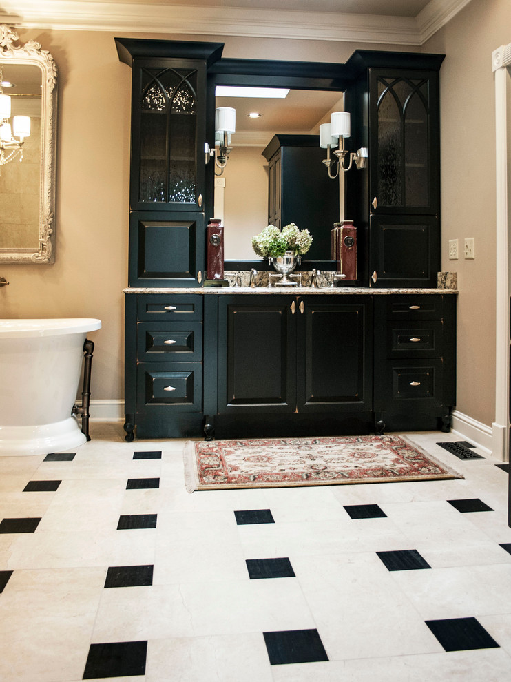 Freestanding bathtub - traditional master multicolored tile and stone tile marble floor freestanding bathtub idea in Nashville with furniture-like cabinets, black cabinets, quartzite countertops, beige walls and an undermount sink