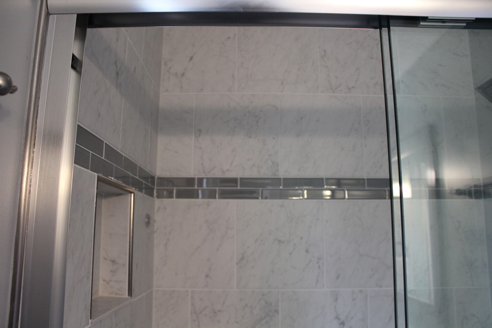 Small classic shower room bathroom in Other with louvered cabinets, grey cabinets, an alcove bath, an alcove shower, a two-piece toilet, grey walls, a submerged sink, marble worktops, grey floors and a sliding door.