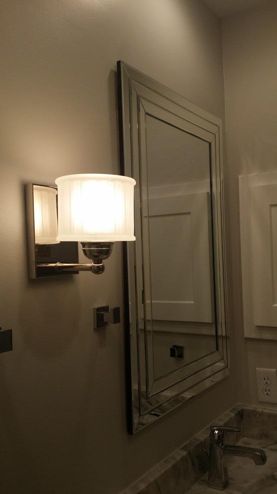Inspiration for a medium sized contemporary shower room bathroom in Kansas City with raised-panel cabinets, white cabinets, a corner bath, a walk-in shower, a one-piece toilet, grey tiles, white tiles, marble tiles, white walls, ceramic flooring, a built-in sink, marble worktops, grey floors and an open shower.