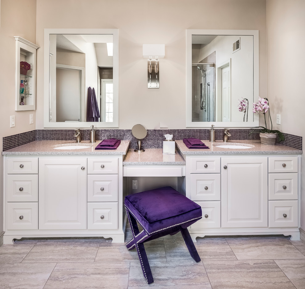 Example of a mid-sized transitional master multicolored tile and mosaic tile porcelain tile corner shower design in Kansas City with raised-panel cabinets, white cabinets, a two-piece toilet, an undermount sink, quartz countertops and beige walls