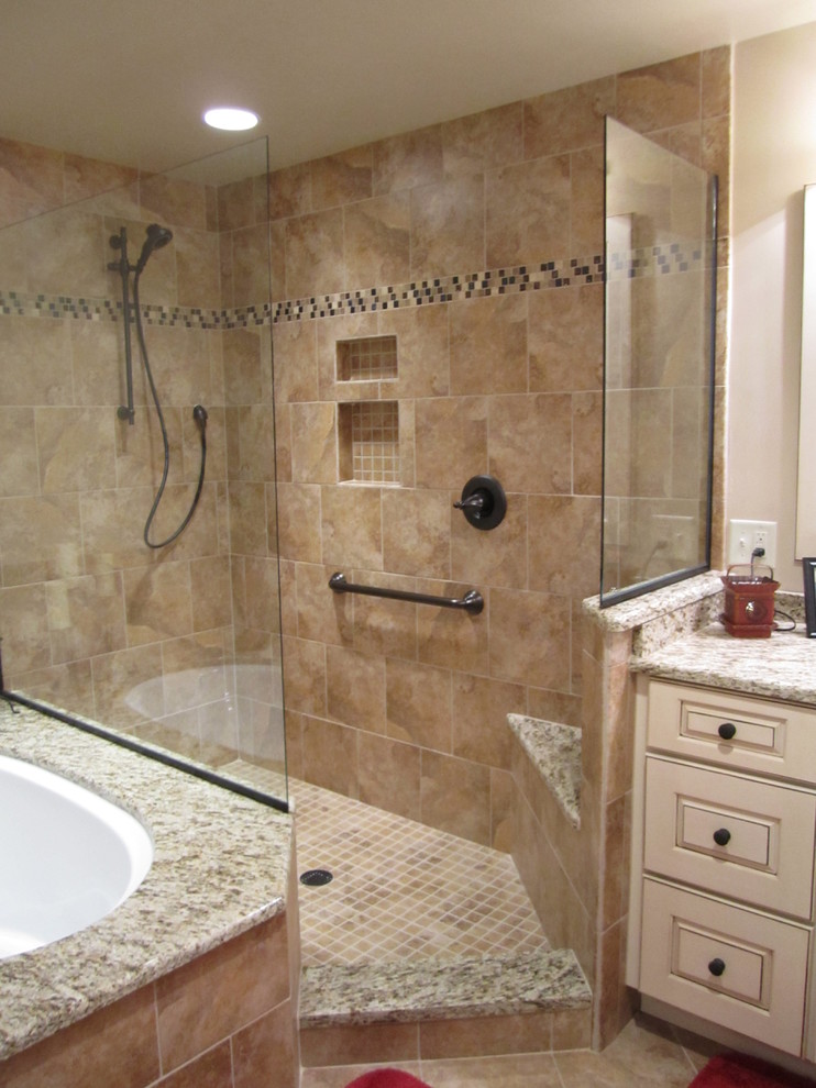 Mid-sized transitional master brown tile and ceramic tile ceramic tile doorless shower photo in Other with an undermount sink, raised-panel cabinets, beige cabinets, granite countertops, an undermount tub and beige walls