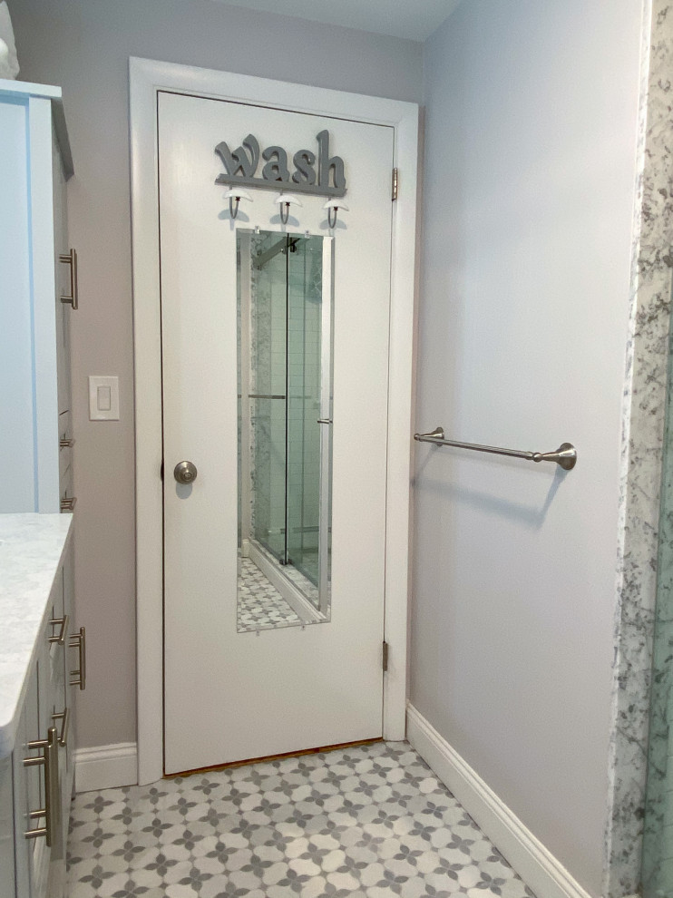 Inspiration for a traditional bathroom in Boston with grey cabinets, an alcove shower, a two-piece toilet, white tiles, metro tiles, grey walls, a submerged sink, a sliding door, double sinks and a built in vanity unit.