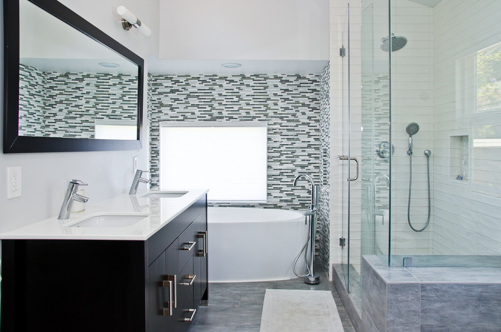Large trendy master gray tile porcelain tile and gray floor bathroom photo in Los Angeles with an undermount sink, flat-panel cabinets, dark wood cabinets, marble countertops, gray walls and a hinged shower door
