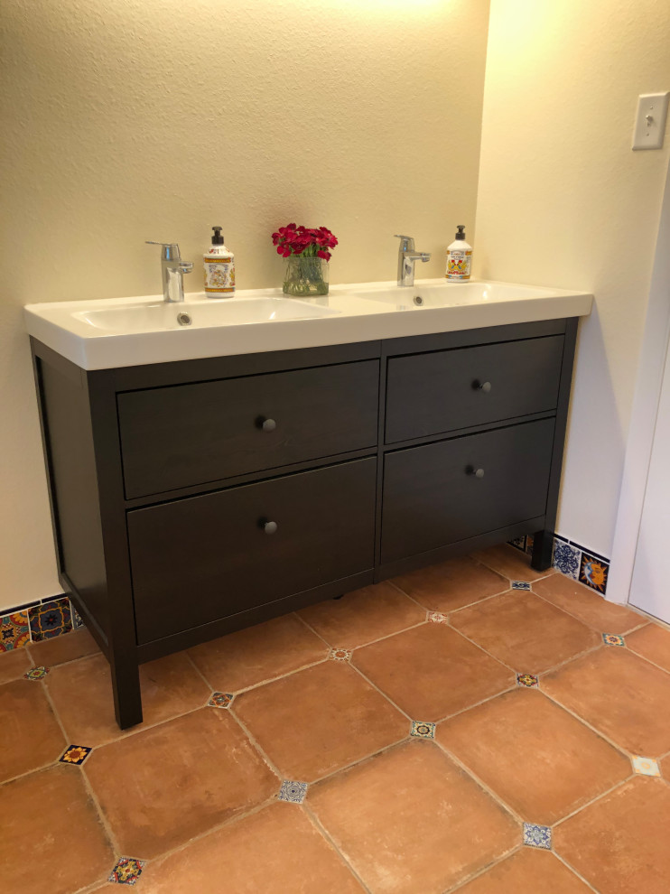 Inspiration for a medium sized classic bathroom in Denver with flat-panel cabinets, black cabinets, an alcove shower, beige walls, terracotta flooring, an integrated sink, solid surface worktops, orange floors, a shower curtain and white worktops.