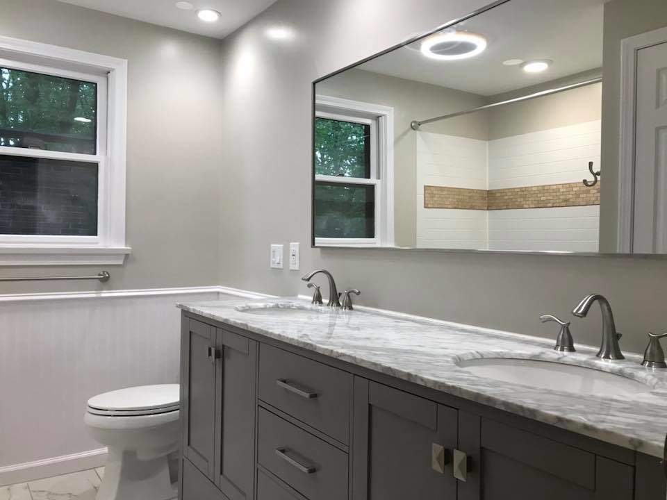 Bathroom - mid-sized transitional 3/4 white tile and ceramic tile marble floor and white floor bathroom idea in New York with recessed-panel cabinets, gray cabinets, a two-piece toilet, gray walls, an undermount sink, granite countertops and gray countertops